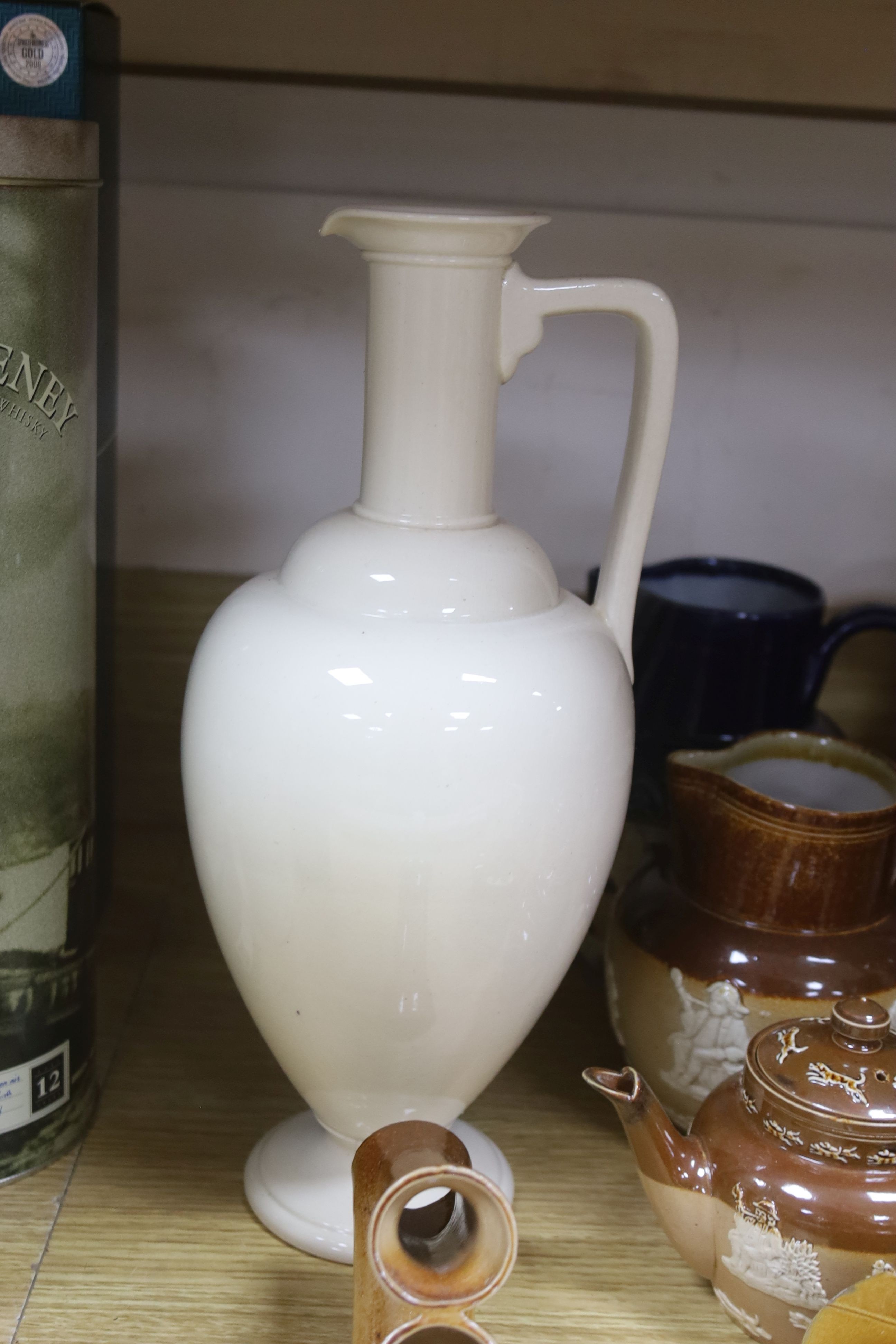 A group of Doulton stoneware: jugs, a teapot, butter dish and a pipe salesman's model